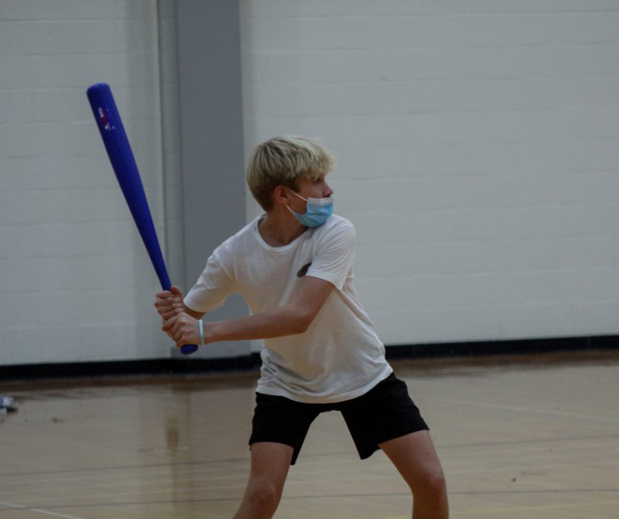 Freshman Garrett Willwerth gets ready to swing during a game of wiffle ball during the SO Unified Club meeting on Friday, Nov. 12.