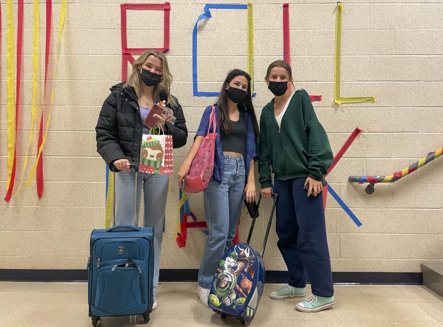 Senior Jessie Lambert, junior Sophia Murray and junior Jula Utzschneider carry suitcases and tote bags for Anything but a Backpack day.