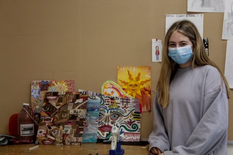 Senior Eve Roiter stands next to her AP Art class projects on Wednesday, Dec. 1.