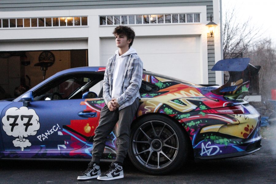 Sophomore Ryan Ledoux with his familys Porsche 911 GT3 that he races for charity.