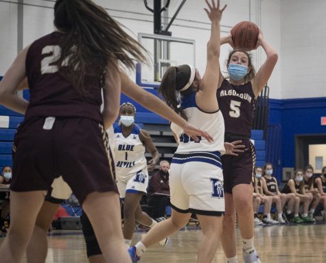 Senior Nicole Egizi throws an overhead pass to her teammate in the girls basketball game against Leominster on Jan. 13, 2022.