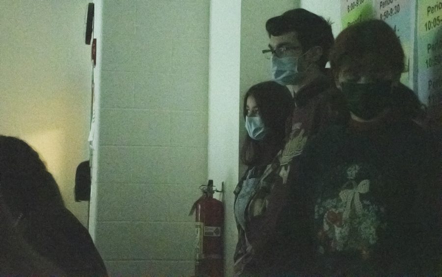 Students in Dr. Christina Smiths Period 3 AP Psychology class huddle in the corner during the ALICE drill on Dec. 12, 2021. The ALICE protocol requires all the lights in the classroom to be turned off.  