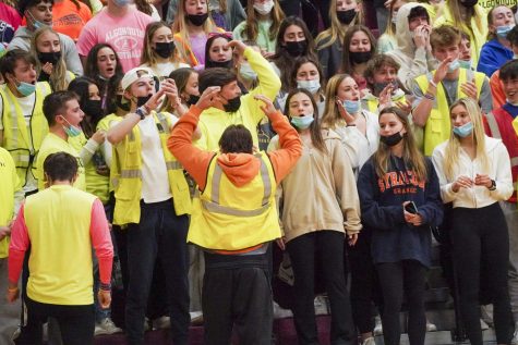 Senior Coleman Hostage leads the student section at the boys basketball game on Dec. 17, 2021. 