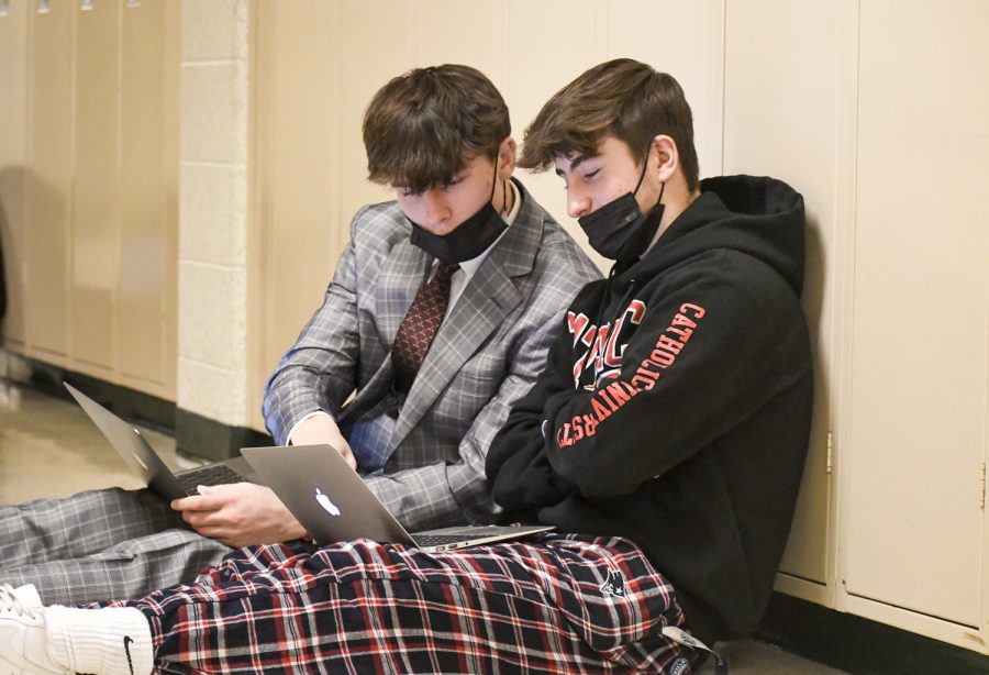 Seniors Tommy Hauk (left) and Patrick Obrien (right) help each other out during work time on Dec. 22. As of Jan. 3, students are not allowed to do group work that involves them being within three feet of one  another. 