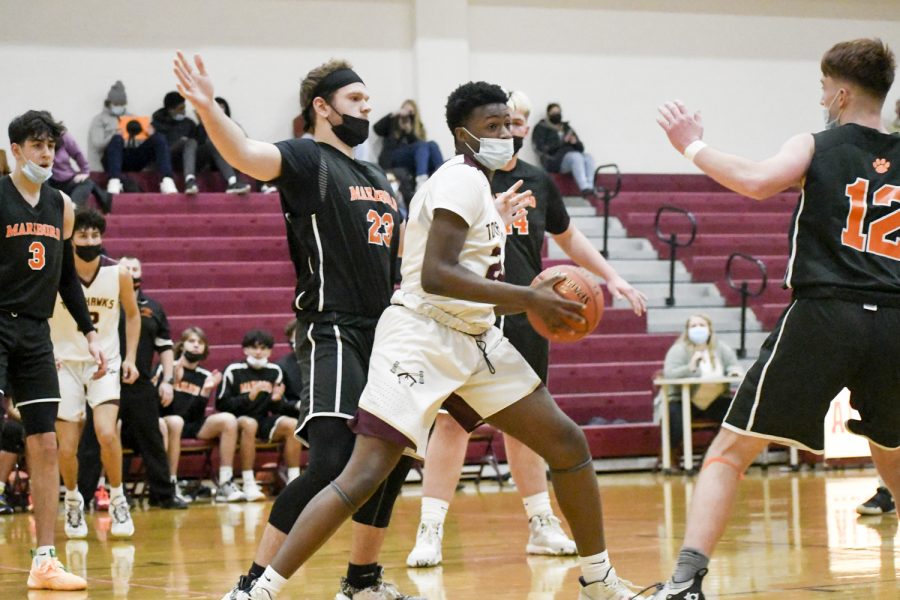Sophomore Patrick Biamou looks for a teammate to pass the ball to in the boys varsity Basketball game Thursday, January 6, 2022.