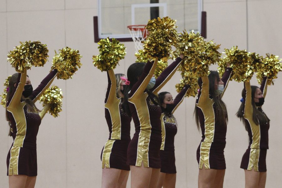 The winter cheerleaders perform at the boys varsity basketball game on Dec. 17, 2021 during halftime. 