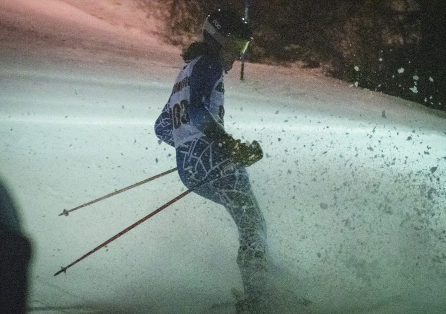 On Feb. 10 2022, the Algonquin ski team competes against various other schools at Ward Hill.  Senior Ben Guggina sprays snow towards the spectators after finishing the course.