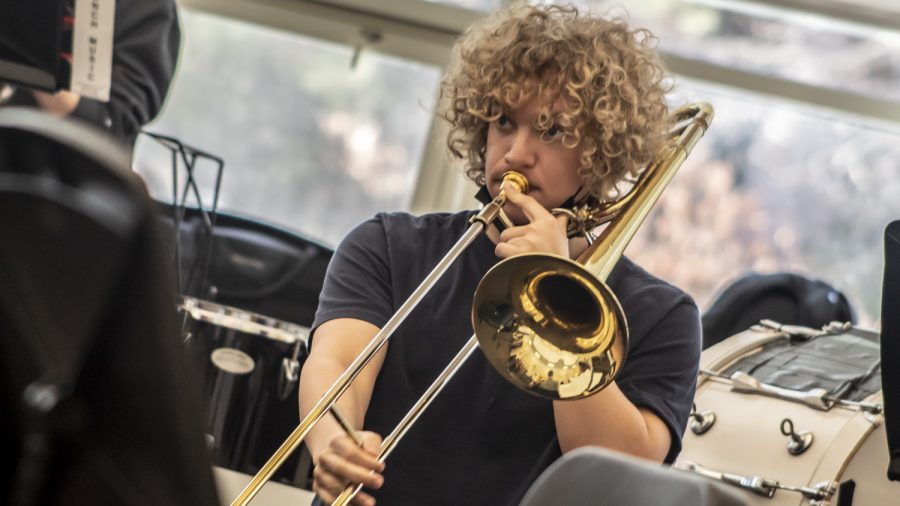 Junior Greg Roumainstev plays his trombone during band practice March 4. Roumainstev is excited about learning new pieces and meeting new people at All-States music festival.  