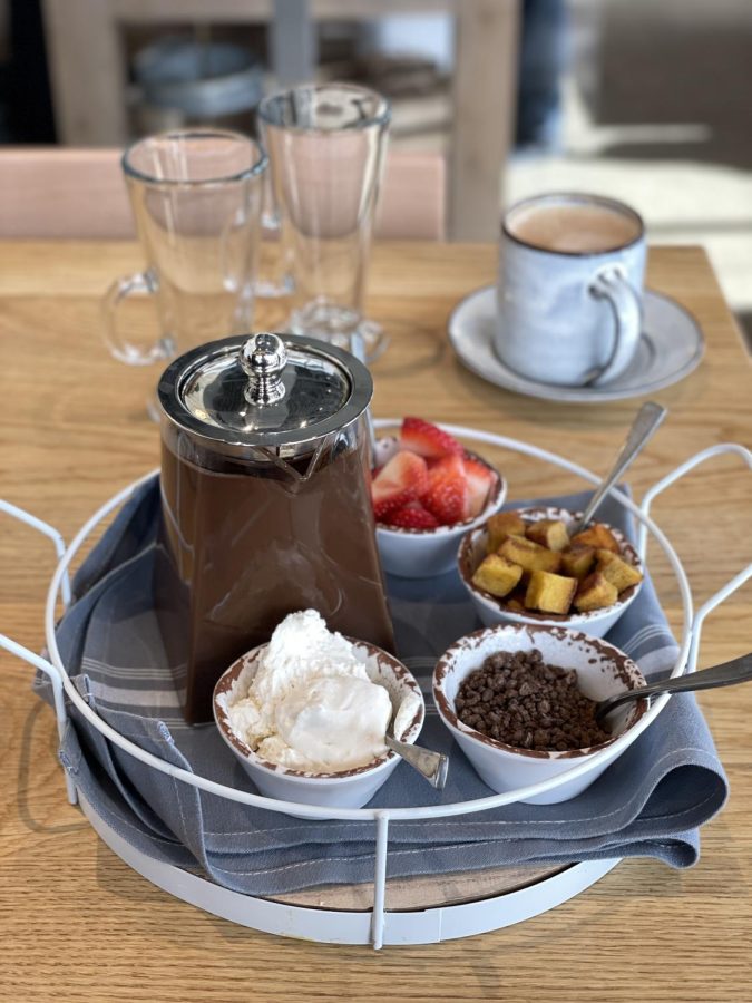 The French hot chocolate, a current special, comes with sides of chantilly, chocolate shavings, mini french toast bites, and sliced strawberries.  