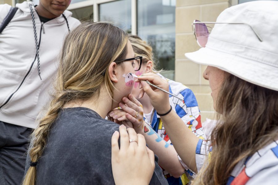Students apply face paint to each other during Wacky Wednesday.