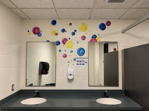 Colorful, painted bubbles brighten up the girls bathroom outside of the cafeteria. 