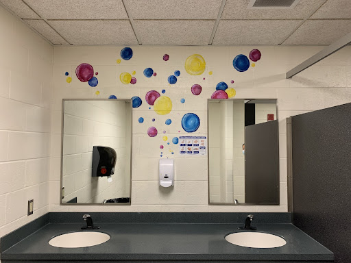 Colorful, painted bubbles brighten up the girls' bathroom outside of the cafeteria. 