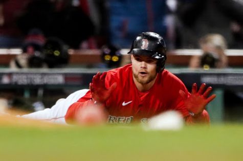 Red Sox second baseman Christian Arroyo dives in to a base in a home game at Fenway Park on October 19, 2021.