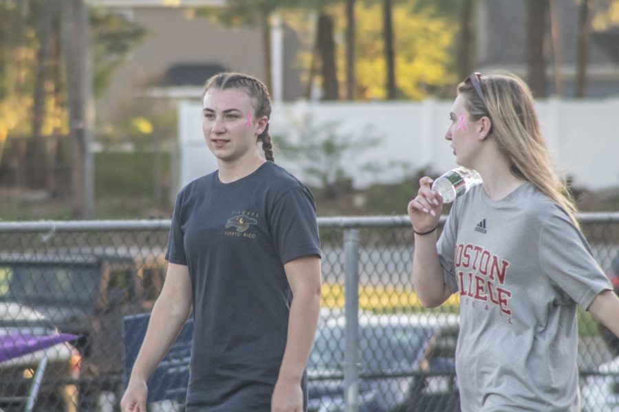 Juniors Bitsy Reynolds and Mia Price walk around the track in support of Relay for Life an organization dedicated to raising money and awarness for cancer.
