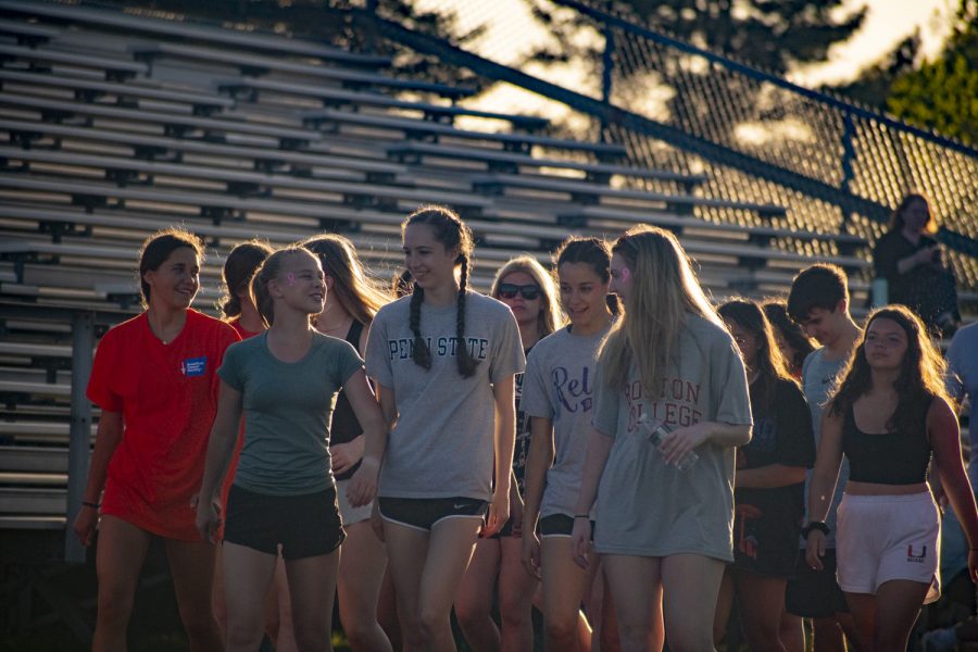 Participants of the Relay for Life event start walking as the sun sets on May 13, 2022.