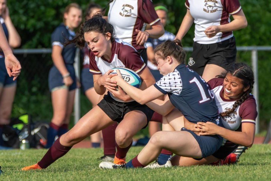 The Girls Algonquin Rugby team plays in a game.