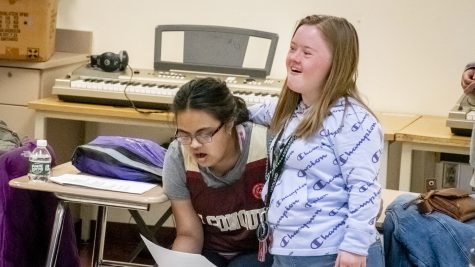 Juniors Norah Shaikh and Olivia Cheney practice the song This Is Me at a Unified Singing rehearsal on May 10, 2022.