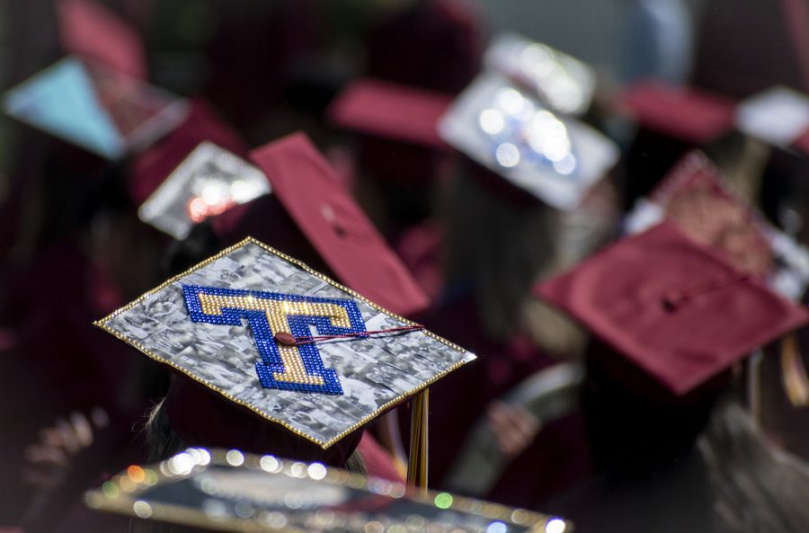 Many students of the 2022 graduating class decorated their caps, often with a college logo.