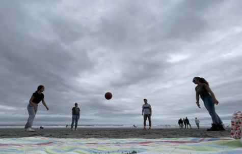 My family and I playing four square on the beach in Maine.