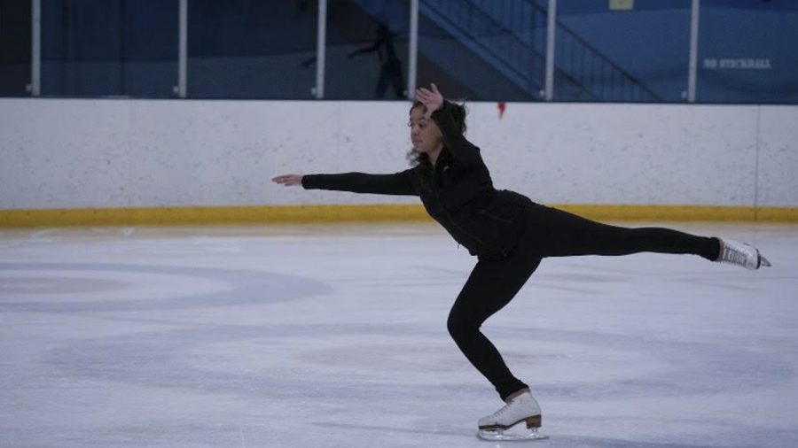 Junior Sara Medina lands a jump at figure skating practice.