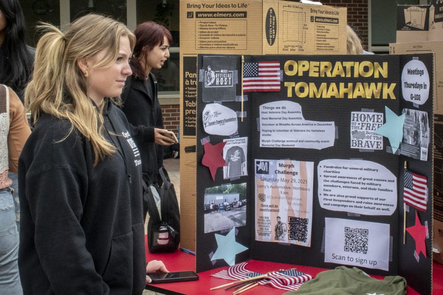 A member of Operation Tomahawk stands in front of their sign during the Activities Extravaganza on Wednesday, September 21.