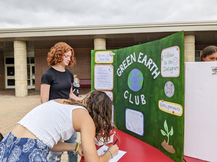 The Green Earth Club gains a new member, senior Alexa Butterfield, as senior Lee Gould informs her about the club during the Activities Extravaganza on Sept. 21, 2022.