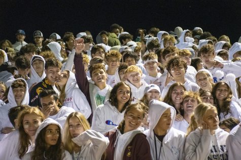 Fans enjoy a home football game while showing their school spirit. The game, which was against Catholic Memorial, had a white out theme.