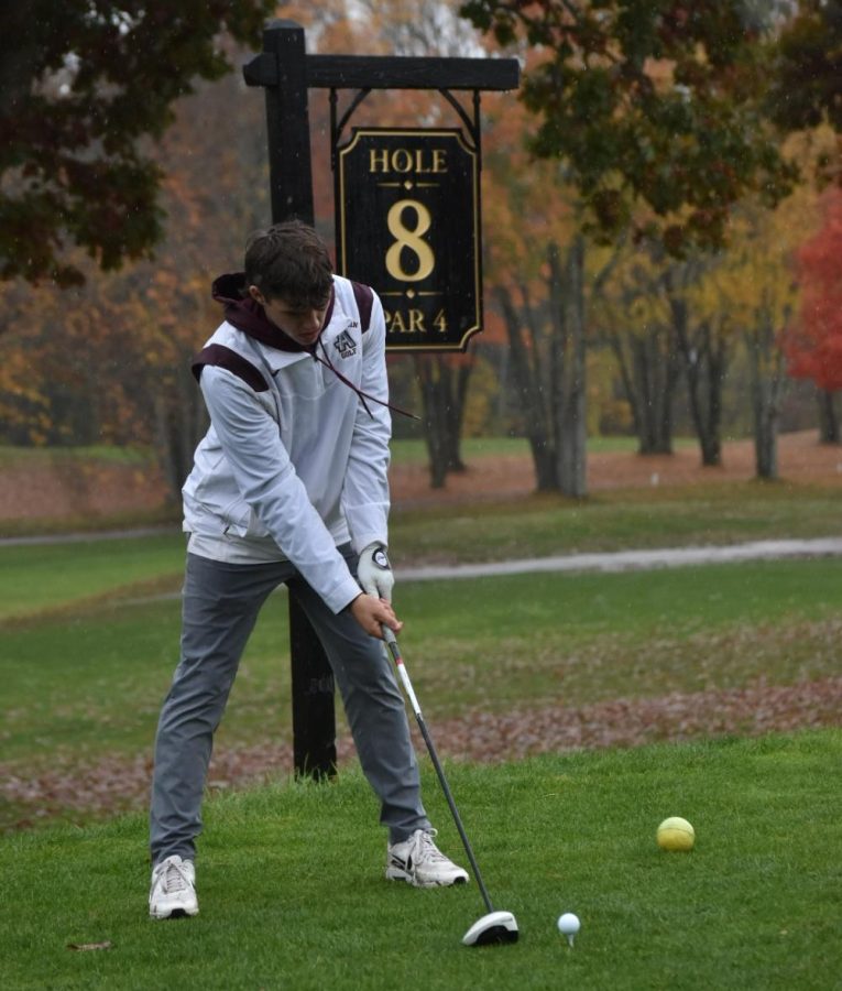 Junior Brennan Rice prepares to hit a golf ball at the district tournament on Oct. 17, 2022. The tournament was held at Heritage Country Club in Charlton.
