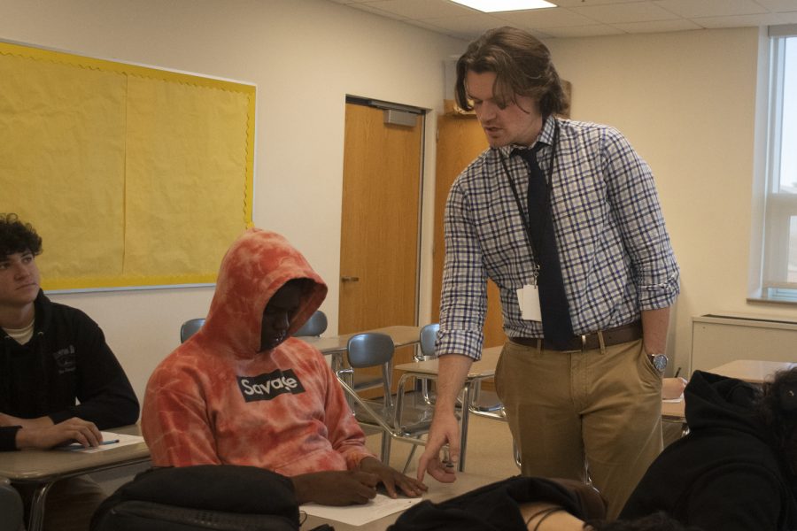 Math teacher Benjamin Burger helps a student in his class on Thursday, Oct. 27, 2022.