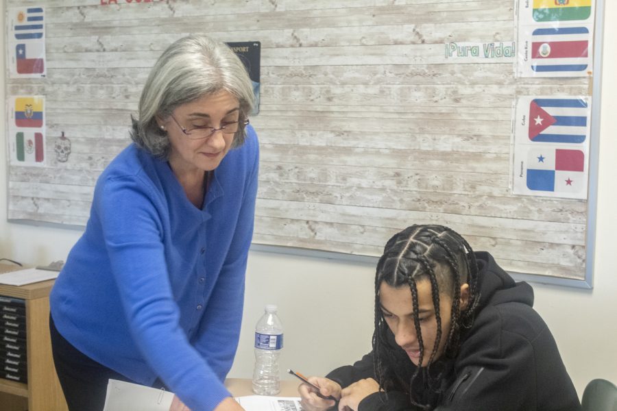 New World Language teacher Agustina Harmon works with junior Lincoln Alston during a Spanish II class.