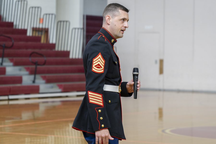 Marine Gunnery Sergeant Andrew Roberson answers a question from a student at the Veterans Day Assembly, which was hosted by Operation Enduring Freedom.