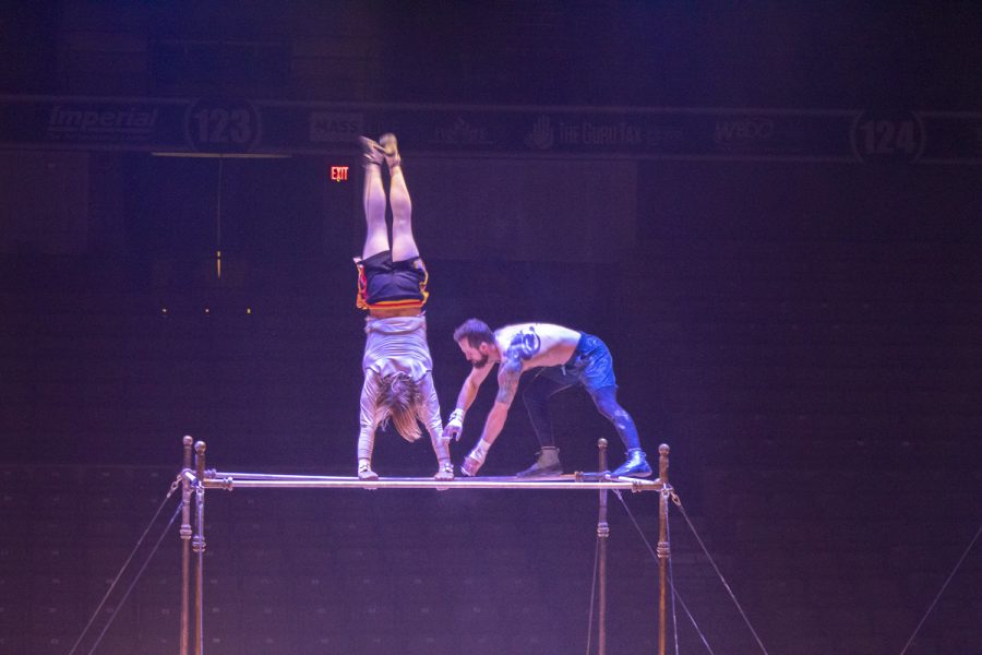 Two Cirque du Soleil performers warm up on the bar for their opening night in Worcester on Jan. 12, 2023. 