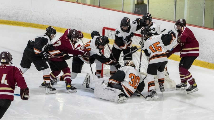 During the boys’ hockey game on Dec. 28, players fight for the puck in front of the Marlborough net. Algonquin beat Marlborough 5-3 to win the Daily News Cup.