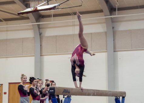 Senior Bitsy Reynolds performs her routine on the beam during a meet on Jan. 13.