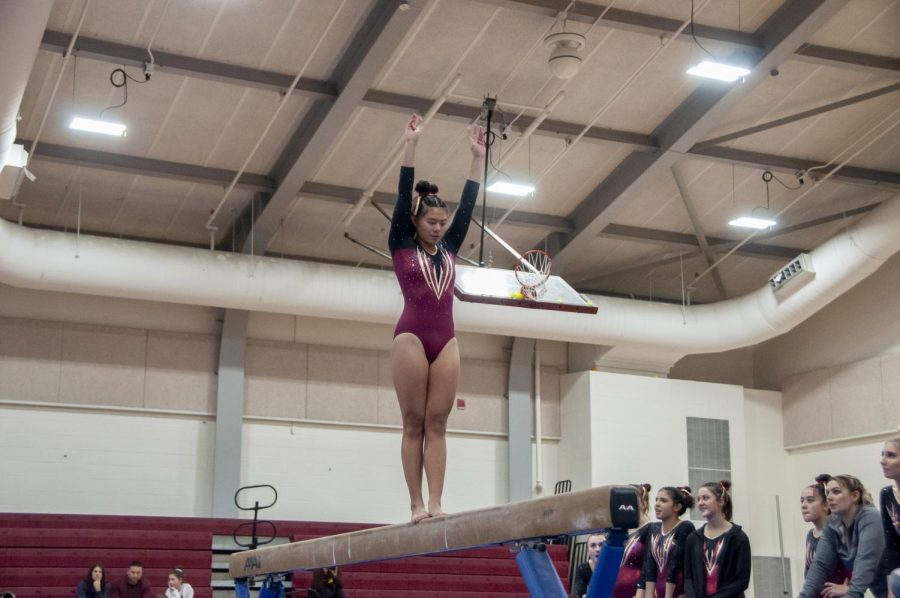 Junior captain Maddie Ho performs her routine on the beam during a meet on Jan. 13.