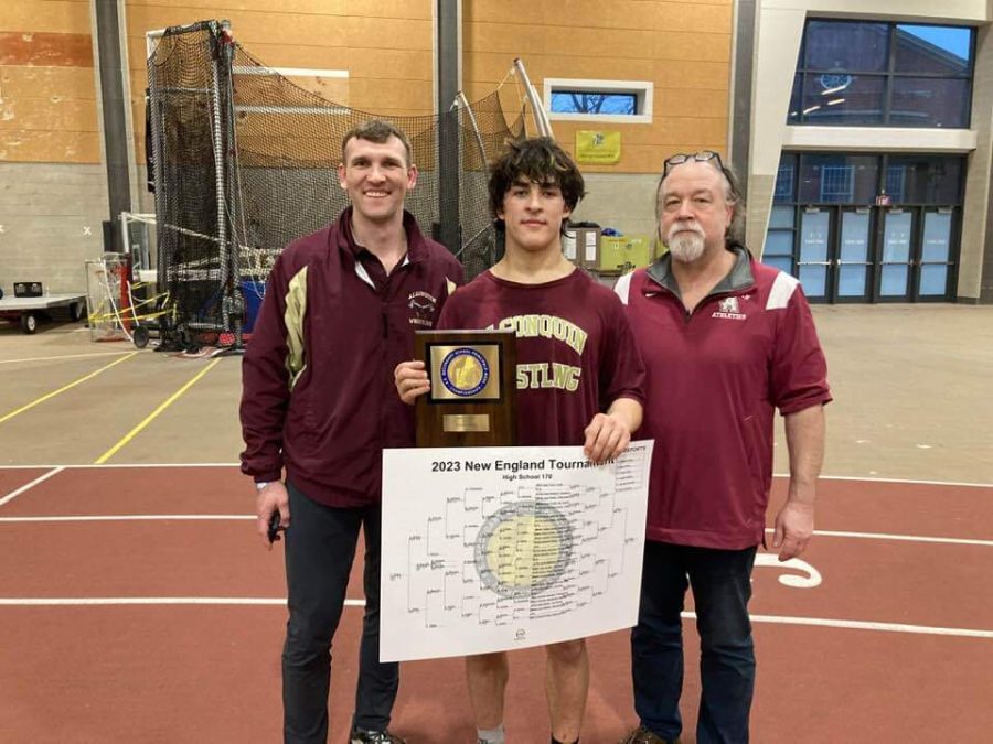 Senior Rafael Knapp poses with wrestling head coach Brian Kramer and assistant coach James Gray after winning the New England wrestling championship.