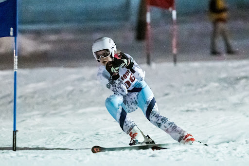 Senior Jula Utzschneider skis down a slope. The girls ski team ended with a record of 4-1 and won the CMASS tournament.