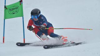 Senior Michael Desio skis down a slope. The boys ski team ended with a record of --.