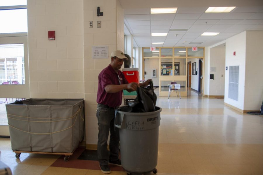 Algonquin custodians like Joao Souza empty trash bins in the cafeteria and hallways many times a day.
