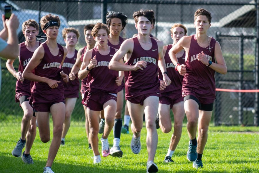 Junior Joe Lamburn (front, center) runs during a cross country meet on Sept. 21. Lamburn recently set a new school record in the indoor track one mile event at 4:31.25.