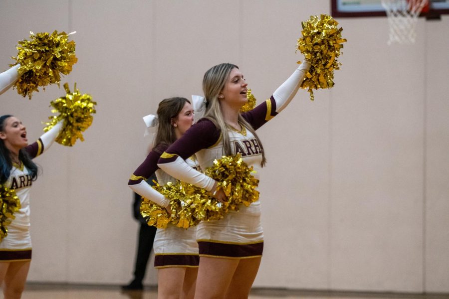 The cheerleading team does a routine at the boys basketball game on Dec. 9.