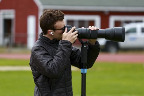 Senior Owen Jones takes photos for the boys rugby team on May 4, 2023. Jones takes pride in his photography and loves taking photos for Algonquin sports teams.
