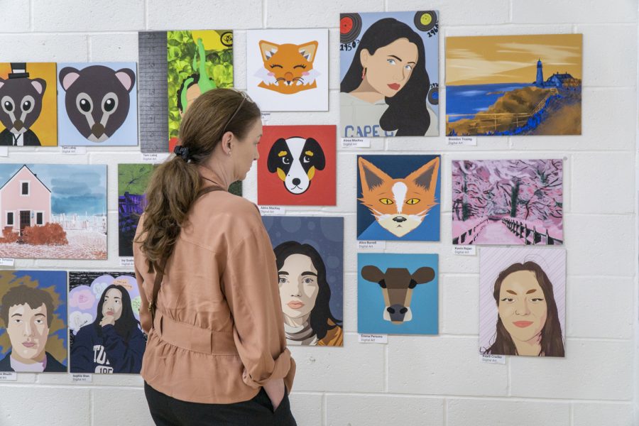 A visitor admires the artwork created by Algonquin students at the Spring Art Show on May 17. The art show will run through May 26.