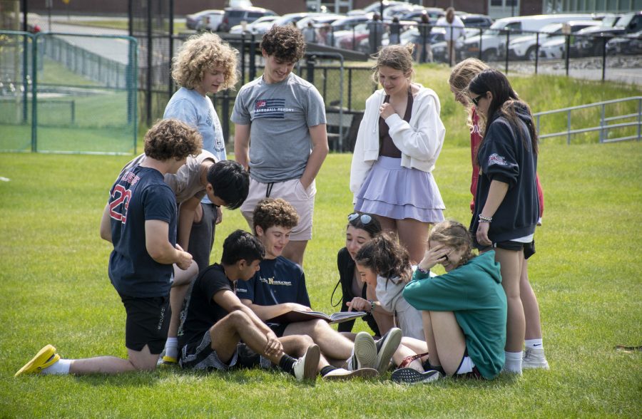 Seniors look through the yearbook as Carnival comes to a close on May 19, 2023.