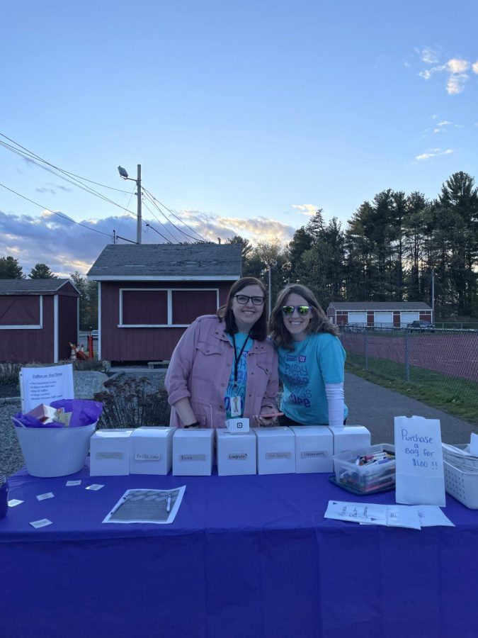 Relay for Life advisers math teacher Lauren Hesemeyer and Spanish teacher Sarah Lawlor sell luminaria bags during the Relay for Life event on May 5.