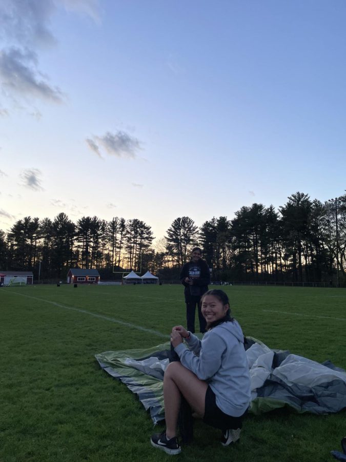 Juniors Maddie Ho and Divya Sathya sit on the lawn during the Relay for Life event. The event ran from 6 p.m. on May 5 to 6 a.m on May 6. During the event, participants of each team took turns walking around the track, with one person from each team walking at all times. 
