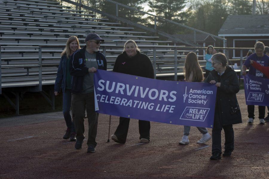 Survivors take the first lap around the track while everybody cheers them on at the beginning of the Relay for Life event.