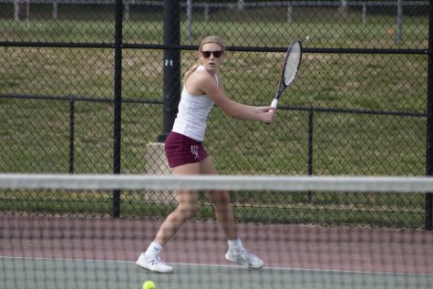 Sophomore Emmy Beauchesne prepares to hit the ball during the Girl’s Tennis match on May 19.