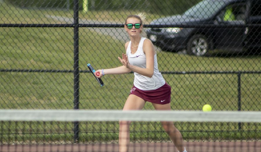 Senior Elly Beauchesne lines up to return a hit during the Girls Tennis match on May 19.