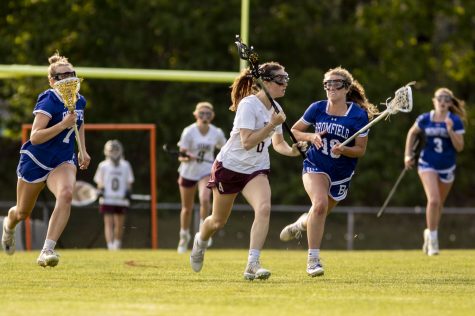 Senior Ava Conigliaro rushes past a defender at the girls lacrosse game against Bromfield on May 23.